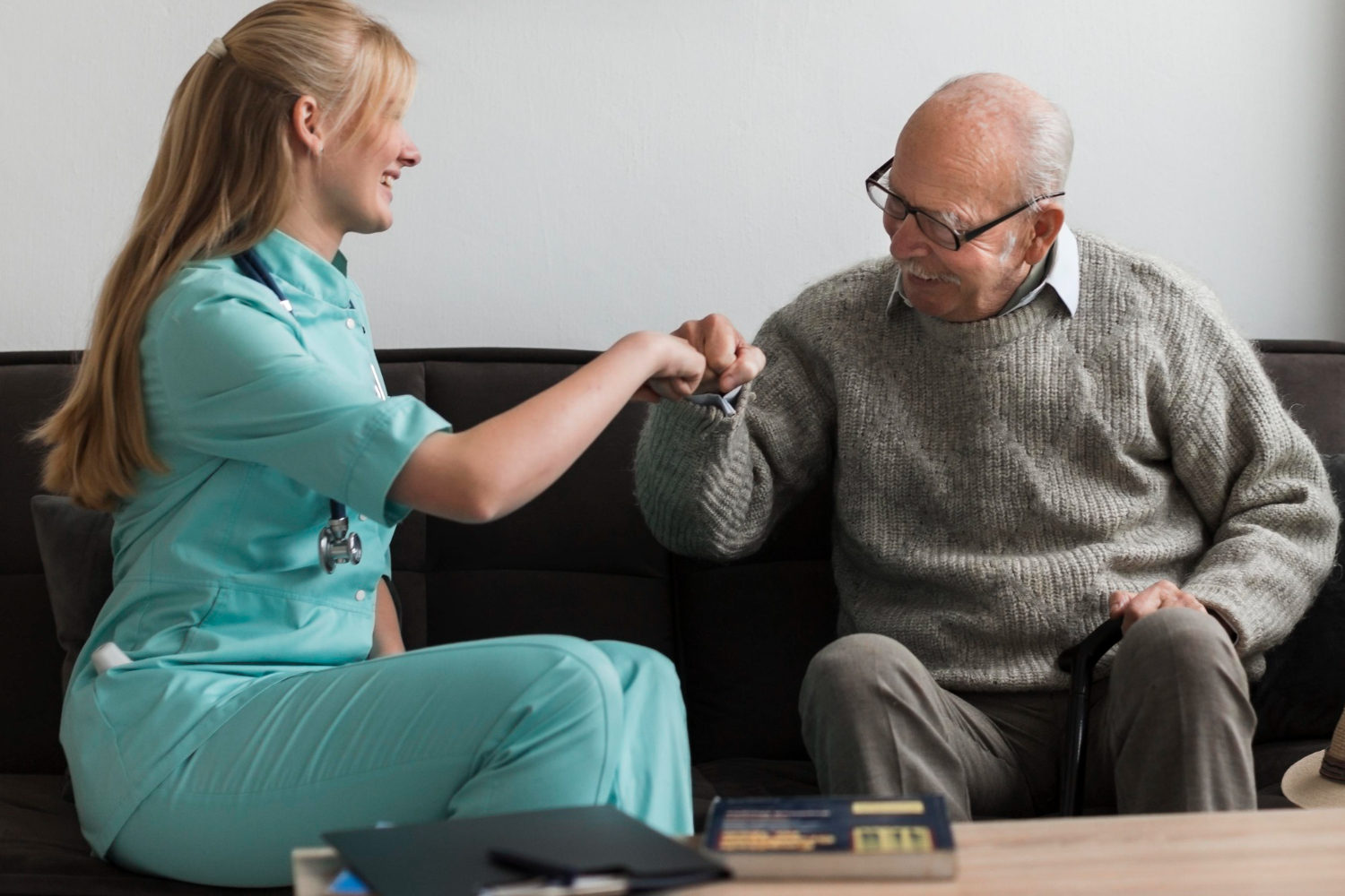 Caregiver helping senior walk at home